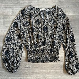 Black and cream colored blouse